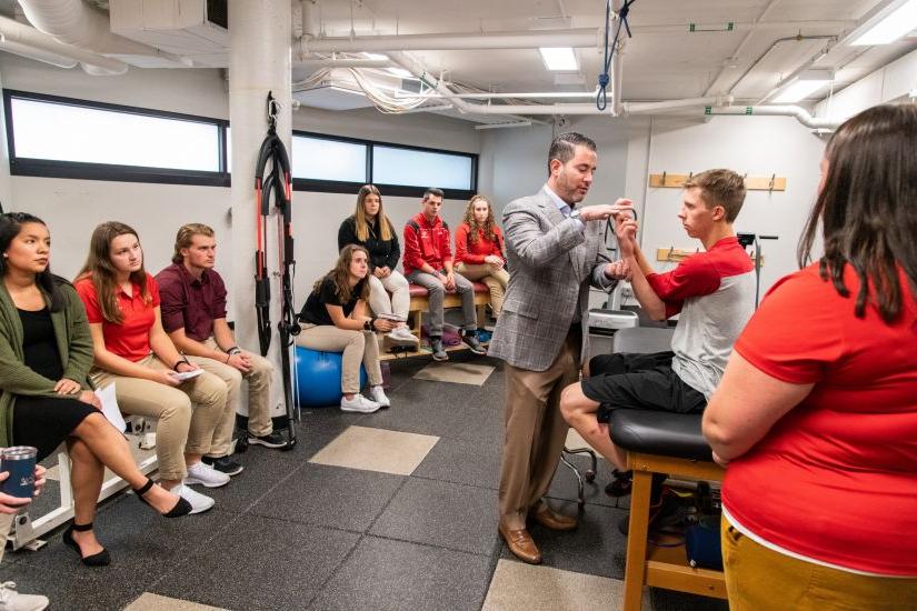 Master of Athletic Training students gather for a demonstration during an athletic training class.