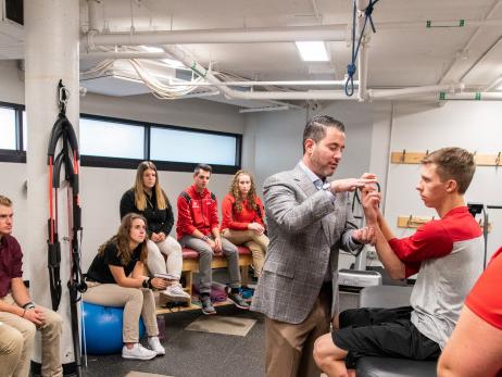 Students gather for a demonstration during an athletic training class.